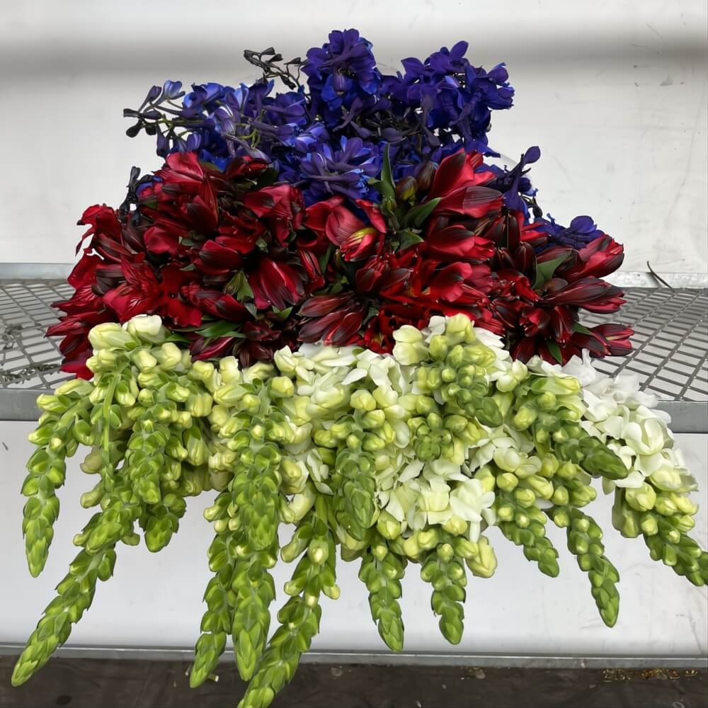 DIY flower box featuring complementary colors with lavender, yellow, and soft orange blooms arranged in a gift-ready display.
