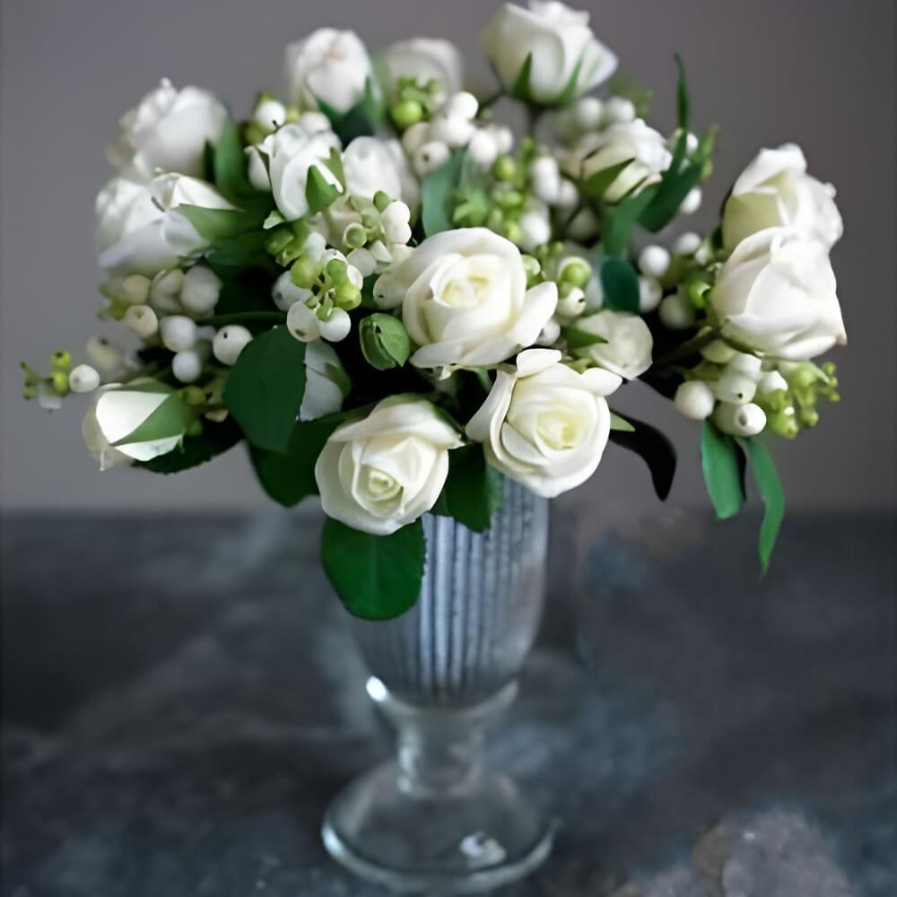 snowberries and roses in vase
